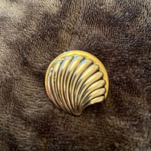 Silver toned pin with gold rim.